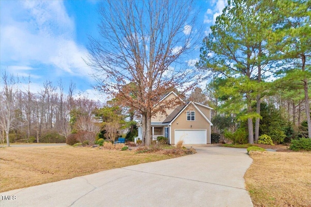 view of front of home with concrete driveway and a front lawn