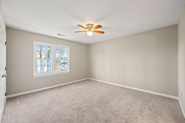 unfurnished room with visible vents, baseboards, ceiling fan, and carpet floors