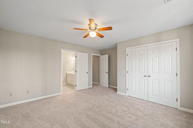 unfurnished bedroom with a closet, baseboards, and light colored carpet