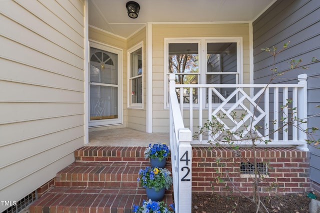 view of exterior entry featuring a porch