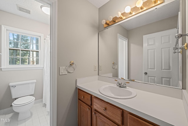 bathroom with tile patterned flooring, visible vents, toilet, vanity, and a textured ceiling