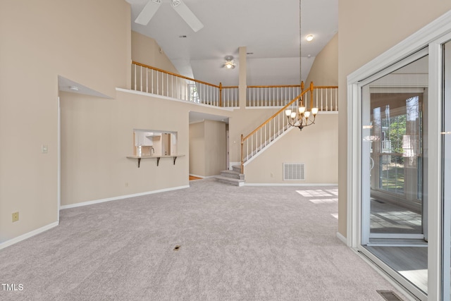 unfurnished living room with visible vents, carpet flooring, stairway, and a ceiling fan