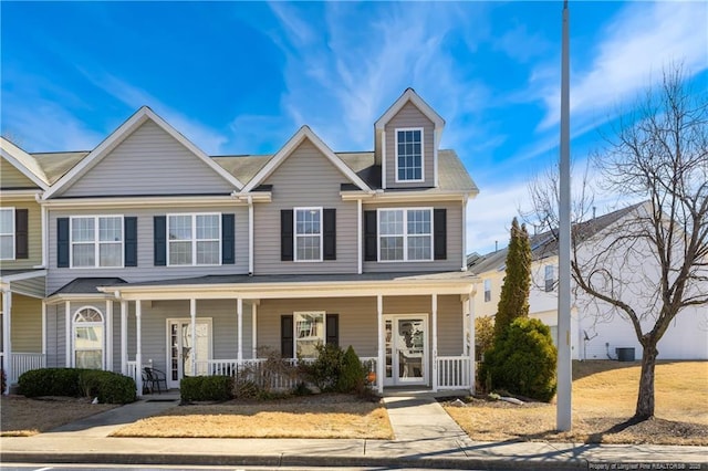 townhome / multi-family property with a porch