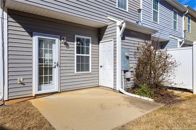 doorway to property with a patio and fence