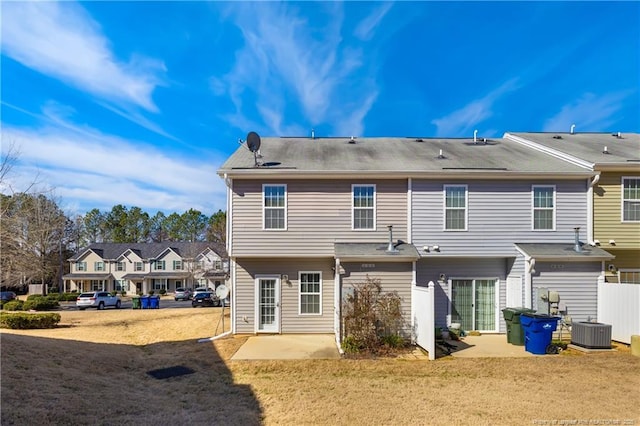 rear view of house with a yard, central AC unit, a patio area, and fence