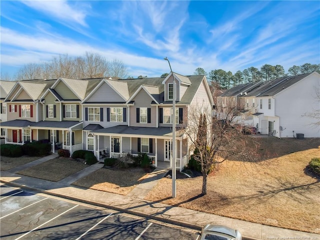 view of property featuring covered porch and a residential view