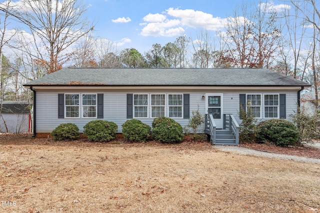 ranch-style home with a shingled roof