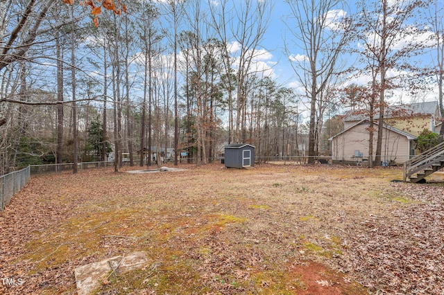 view of yard featuring a fenced backyard, an outdoor structure, and a storage shed