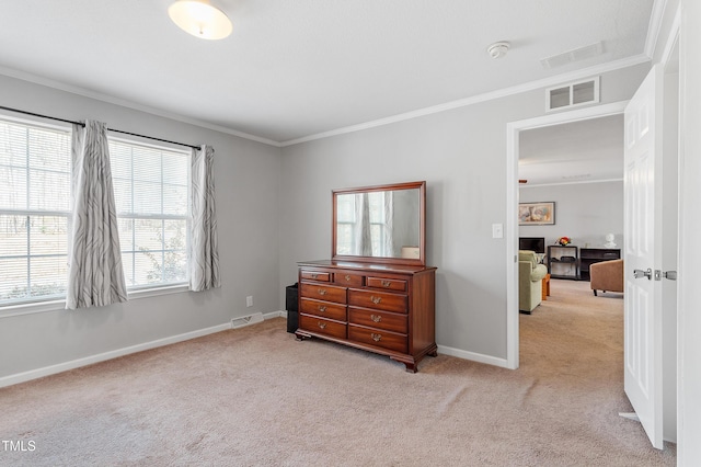 carpeted bedroom with ornamental molding, visible vents, and baseboards