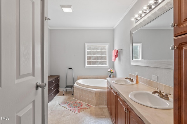 bathroom featuring a garden tub, double vanity, a sink, and crown molding