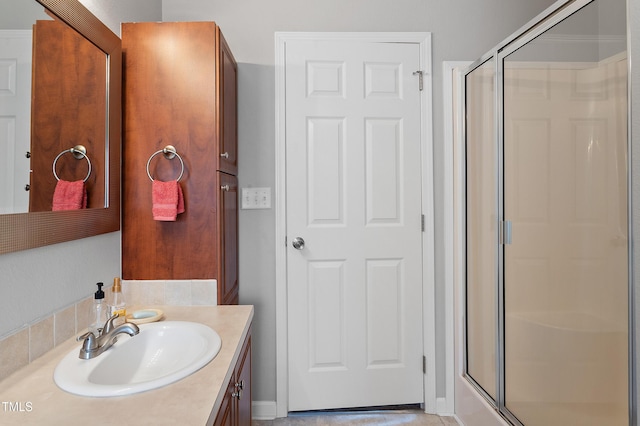 bathroom featuring a shower stall and vanity