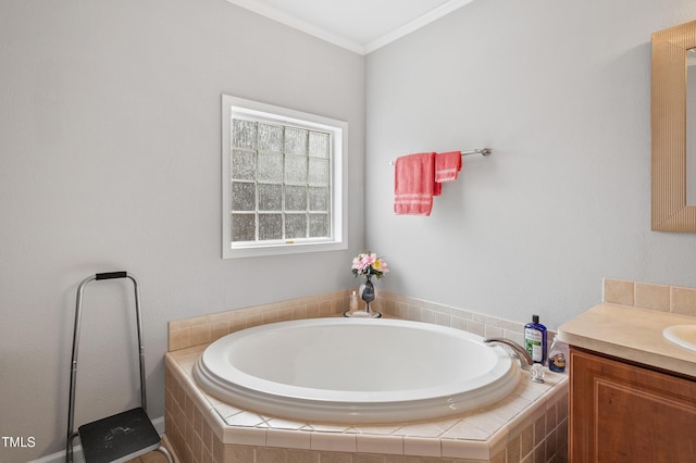 bathroom featuring a garden tub, ornamental molding, and vanity