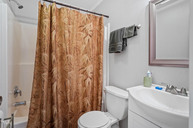 full bath featuring shower / bath combo, a textured wall, vanity, and toilet