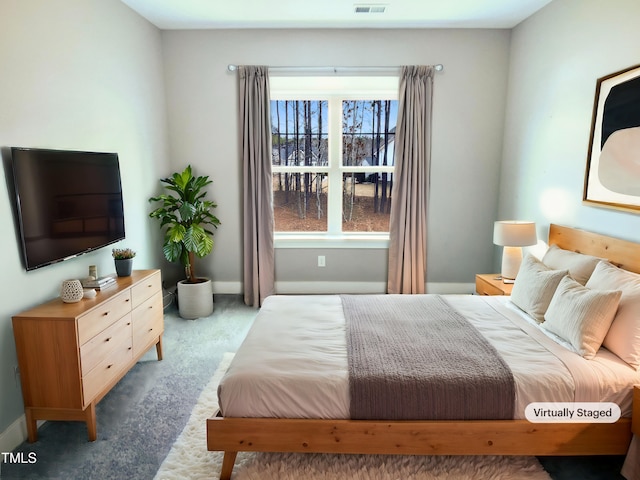 carpeted bedroom featuring baseboards