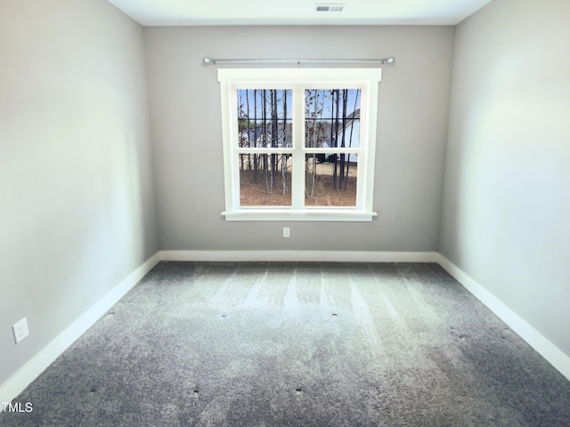 carpeted spare room with baseboards