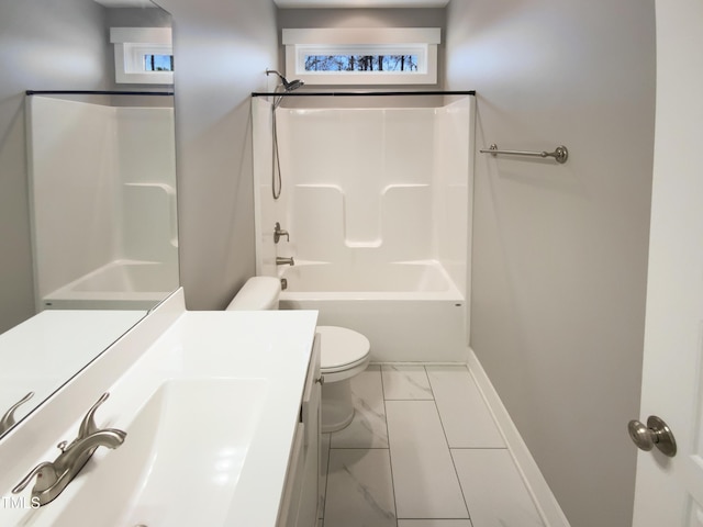 full bath featuring bathtub / shower combination, toilet, vanity, baseboards, and marble finish floor