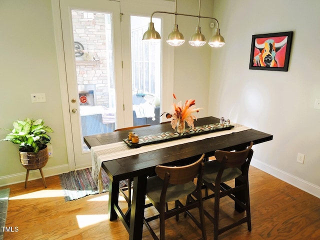 dining room with baseboards and light wood-style floors