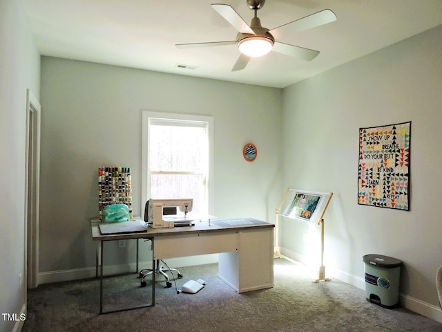 office space with carpet floors, visible vents, ceiling fan, and baseboards