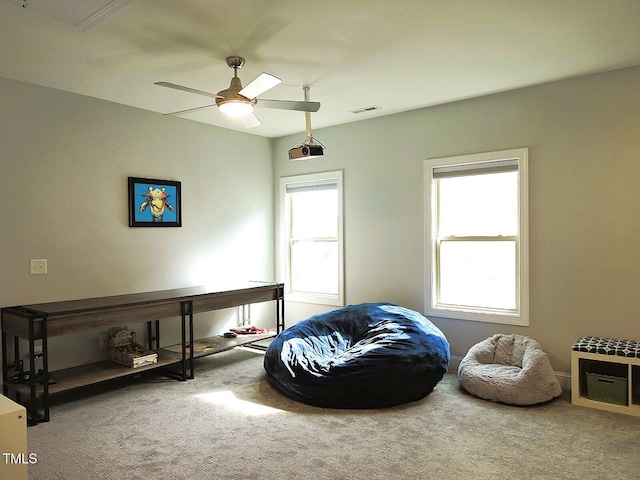 living area with a healthy amount of sunlight, carpet floors, and visible vents