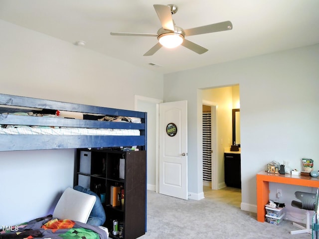 bedroom with visible vents, baseboards, a ceiling fan, ensuite bath, and carpet