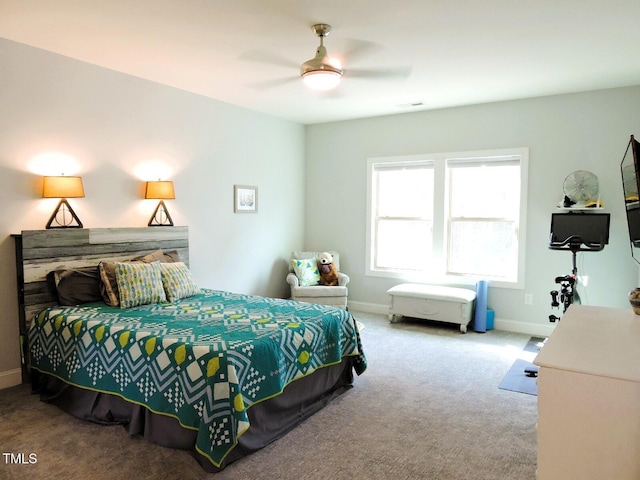 carpeted bedroom featuring ceiling fan, visible vents, and baseboards