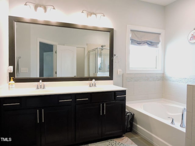 full bathroom with a sink, a shower stall, a bath, tile patterned floors, and double vanity