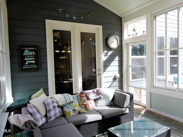 sunroom / solarium featuring lofted ceiling