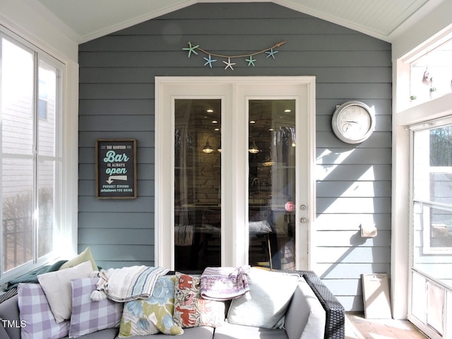 sunroom featuring vaulted ceiling