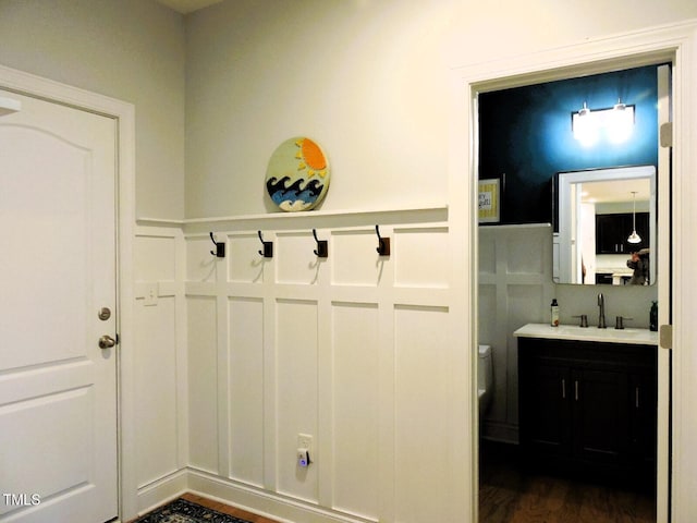 mudroom featuring dark wood-style flooring and a sink