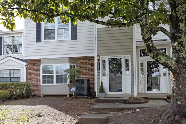 view of front of home with brick siding and central AC unit