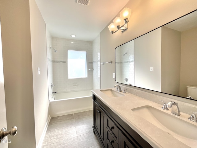 bathroom featuring double vanity, shower / bath combination, a sink, and baseboards