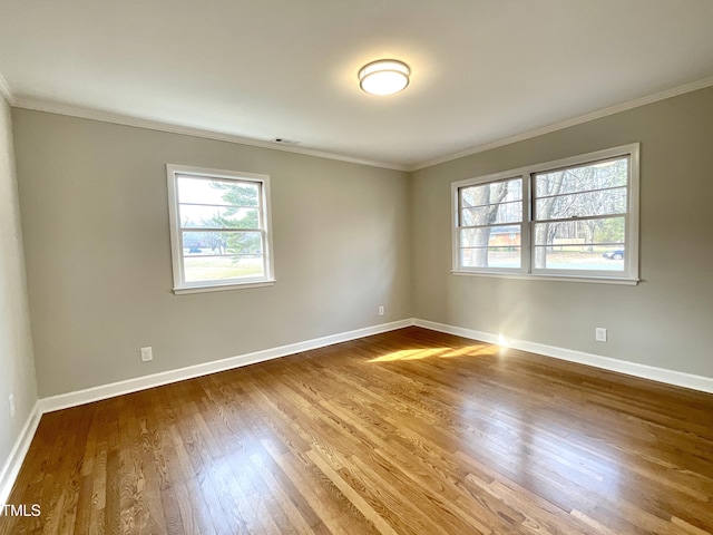 unfurnished room featuring ornamental molding and wood finished floors