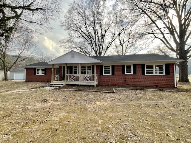 ranch-style home featuring crawl space, brick siding, an outdoor structure, and covered porch