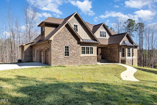 craftsman-style home featuring board and batten siding, a shingled roof, concrete driveway, a front yard, and stone siding