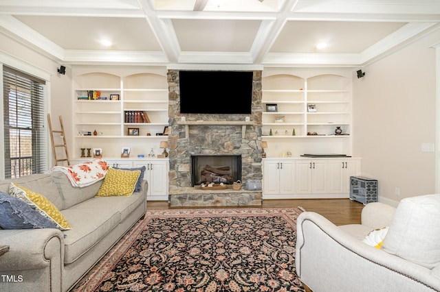 living area featuring coffered ceiling, beam ceiling, a fireplace, light wood-style floors, and crown molding