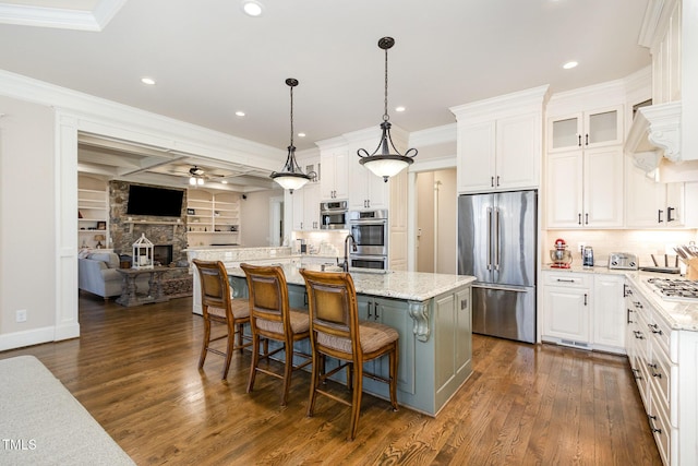 kitchen featuring crown molding, ceiling fan, open floor plan, stainless steel appliances, and white cabinetry