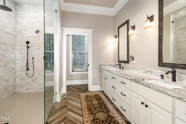 full bath with crown molding, a walk in shower, baseboards, and a sink