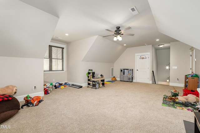 recreation room featuring carpet flooring, visible vents, baseboards, and lofted ceiling