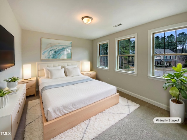 bedroom featuring baseboards, visible vents, and carpet flooring