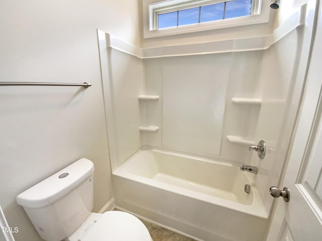 bathroom with bathtub / shower combination and toilet