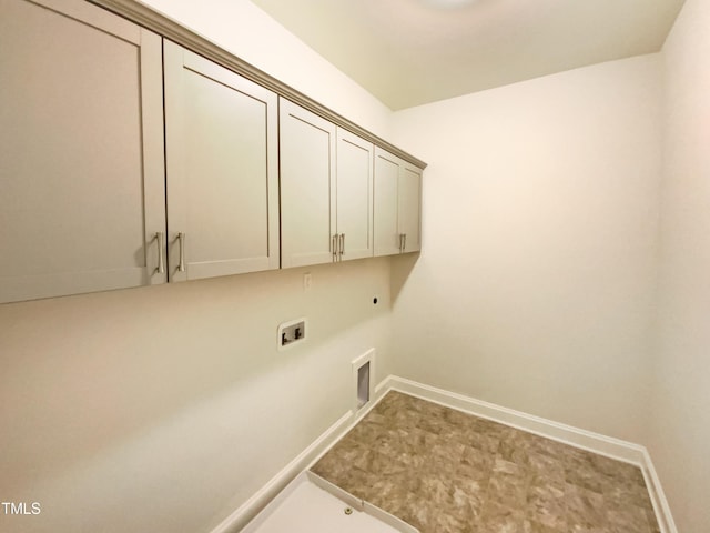 washroom featuring hookup for a gas dryer, hookup for an electric dryer, washer hookup, baseboards, and cabinet space