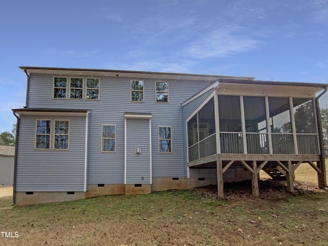 back of house featuring a yard, crawl space, and a sunroom