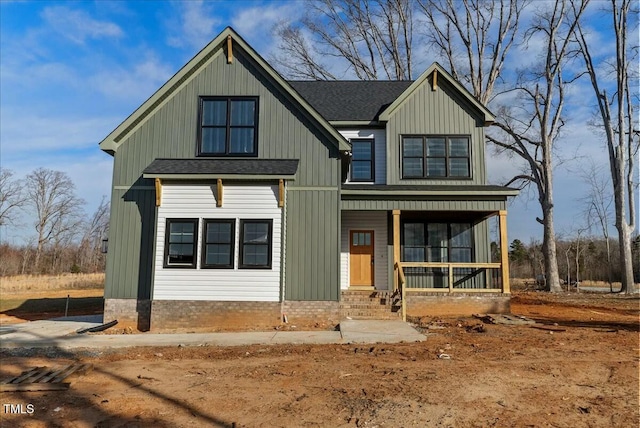 modern farmhouse featuring a shingled roof, a porch, and board and batten siding