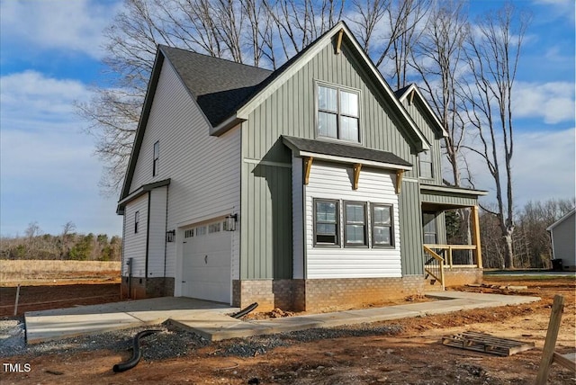 modern farmhouse style home with roof with shingles, concrete driveway, covered porch, board and batten siding, and a garage