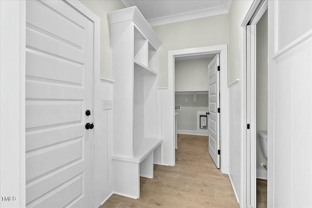 mudroom featuring ornamental molding and light wood-type flooring