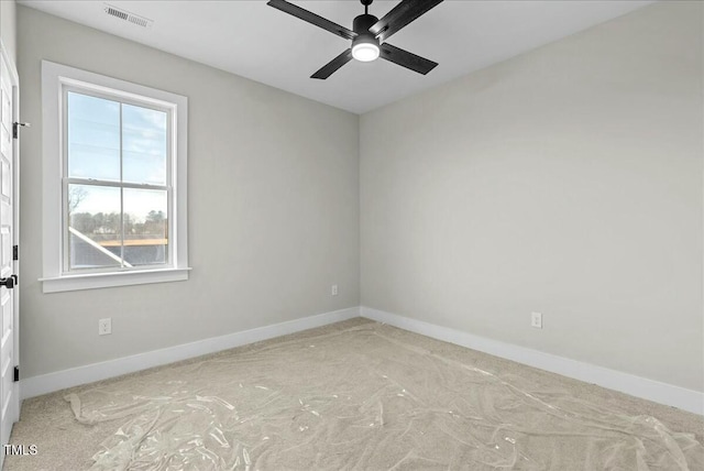 unfurnished room featuring a ceiling fan, visible vents, and baseboards