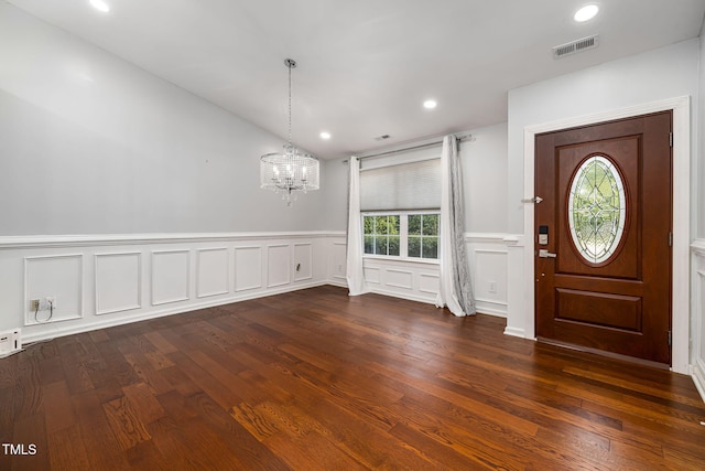 foyer with dark wood-style flooring, recessed lighting, visible vents, and an inviting chandelier