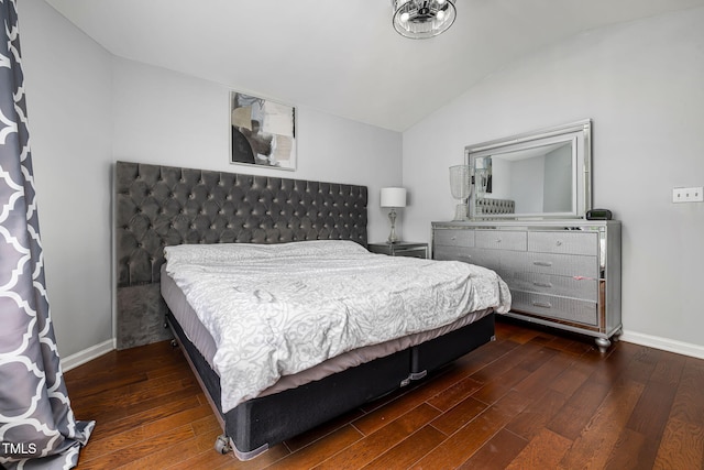 bedroom with lofted ceiling, baseboards, and wood finished floors