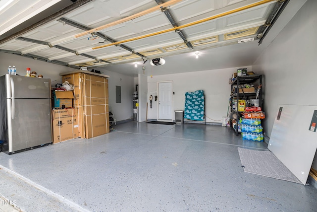 garage with freestanding refrigerator and electric panel