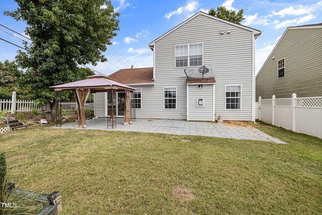 back of house featuring a fenced backyard, a yard, a gazebo, and a patio